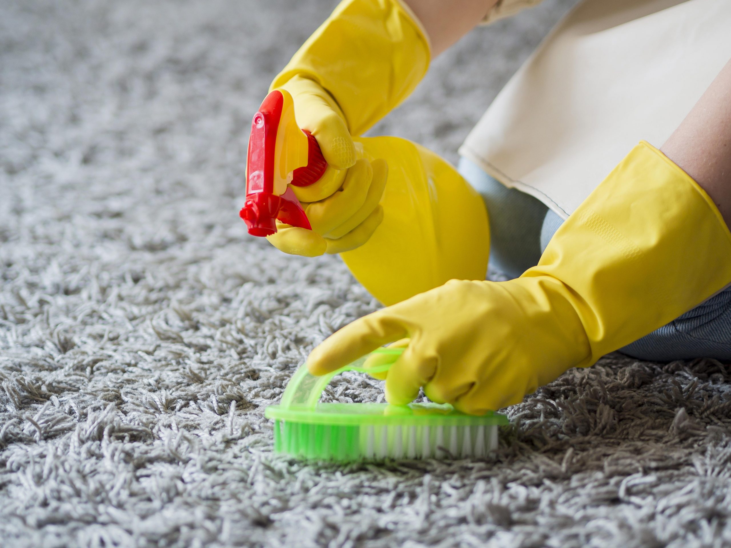 close up disinfecting with cleaning supplies scaled
